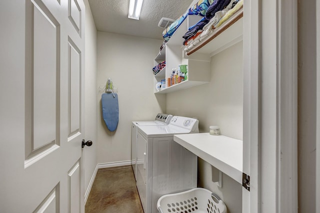 laundry area with a textured ceiling, baseboards, laundry area, and independent washer and dryer