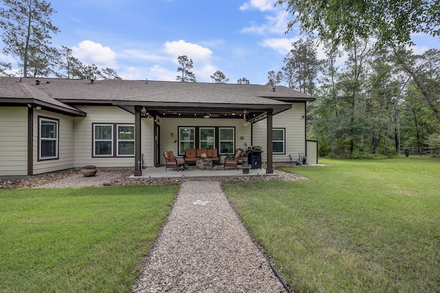back of house featuring roof with shingles, a yard, an outdoor living space, and a patio area