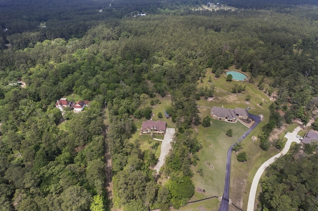birds eye view of property with a wooded view