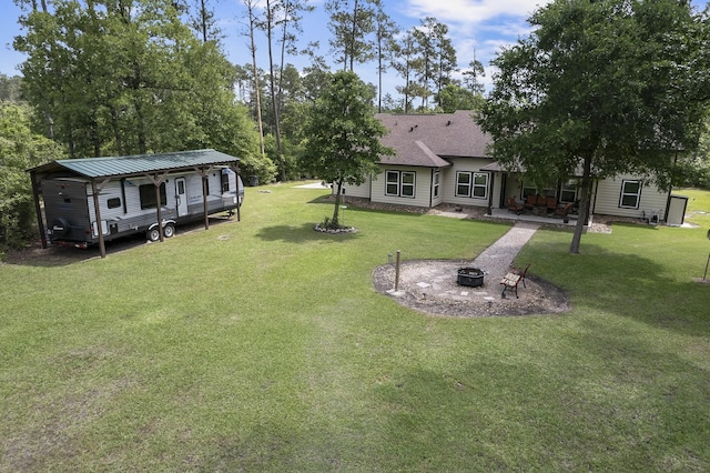 view of yard with a patio and an outdoor fire pit
