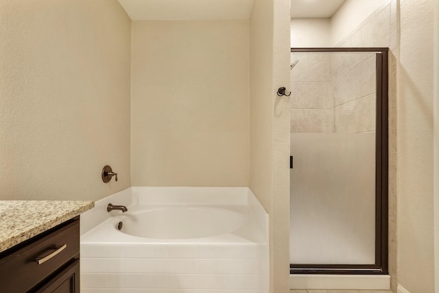 bathroom featuring vanity, a shower stall, and a bath