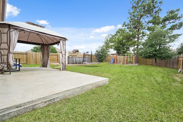 view of yard with a patio, a gazebo, a fenced backyard, and a playground