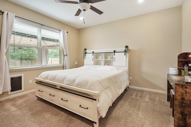 bedroom featuring baseboards, ceiling fan, and light carpet