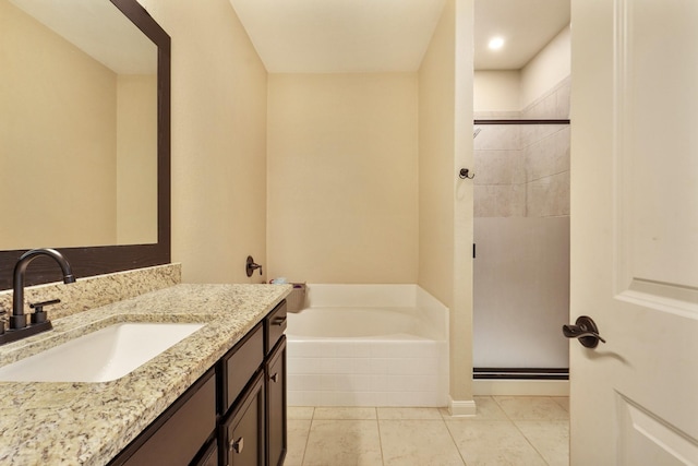 bathroom featuring a garden tub, vanity, tile patterned floors, and a shower stall