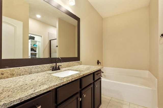 full bathroom with vanity, a shower stall, and a bath