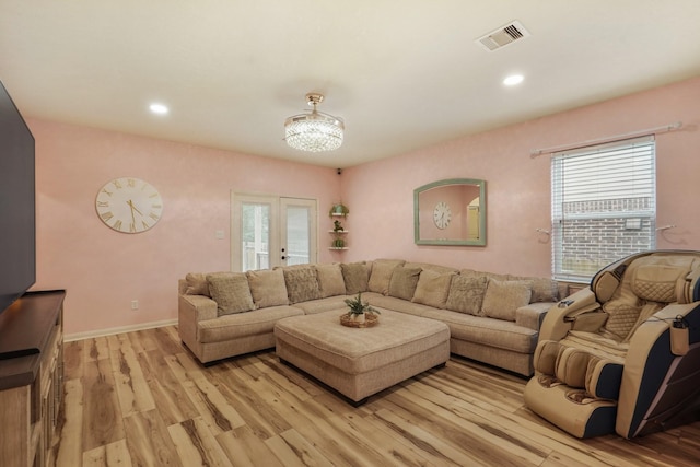 living room with recessed lighting, baseboards, visible vents, and light wood-type flooring