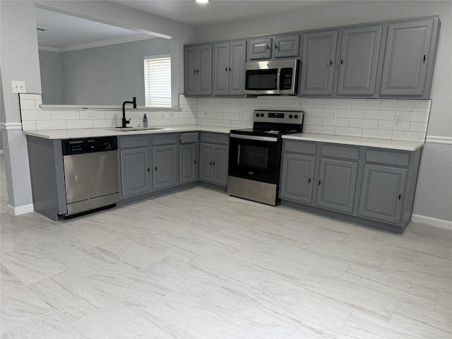 8127 Chancewood Ln, Humble, TX 77338 - kitchen featuring decorative backsplash, light countertops, a sink, gray cabinetry, and stainless steel appliances