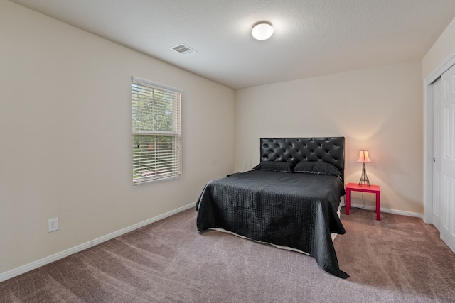 bedroom featuring baseboards, carpet, and visible vents