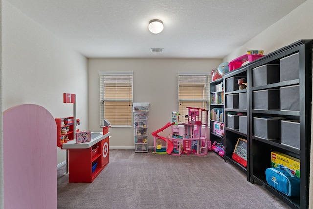 recreation room featuring visible vents and carpet