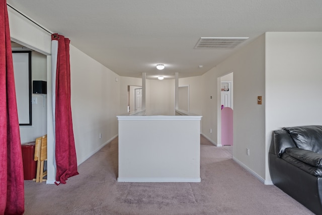 interior space featuring baseboards, light colored carpet, and visible vents