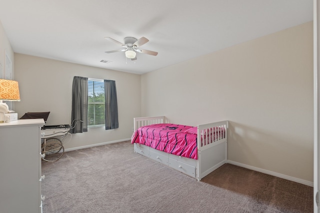 carpeted bedroom with baseboards, a ceiling fan, and visible vents