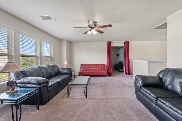 living room with carpet flooring, ceiling fan, and visible vents