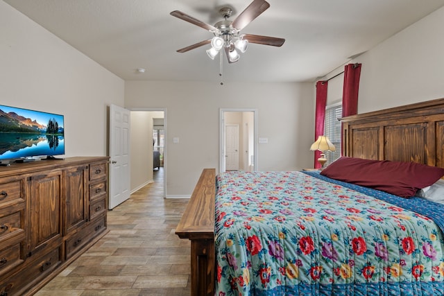 bedroom featuring baseboards, ceiling fan, and light wood-style flooring