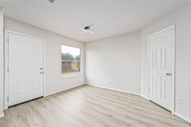 entrance foyer with light wood-type flooring and baseboards