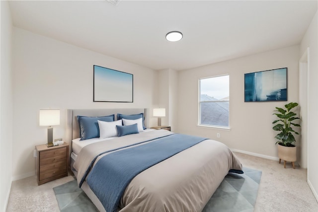 bedroom featuring baseboards and light carpet