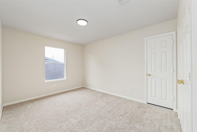 unfurnished room featuring baseboards and carpet flooring