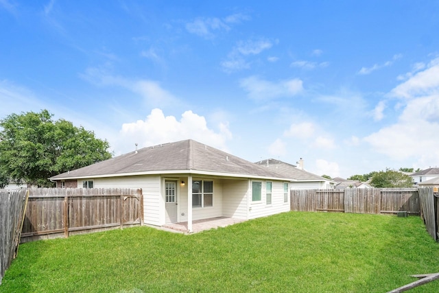 back of property featuring a fenced backyard, a patio, and a yard