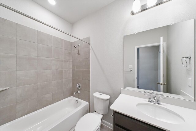 bathroom featuring vanity, shower / bathing tub combination, and toilet