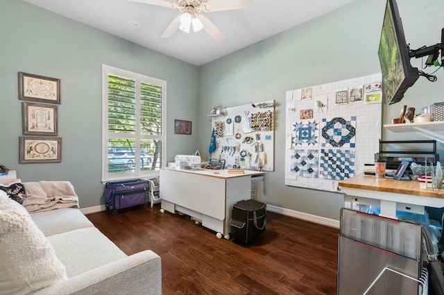 office area featuring a ceiling fan, baseboards, and wood finished floors