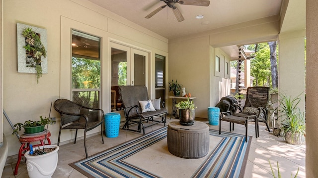 sunroom featuring a healthy amount of sunlight, ceiling fan, and french doors