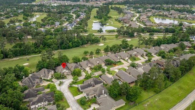 aerial view with a water view, golf course view, and a residential view
