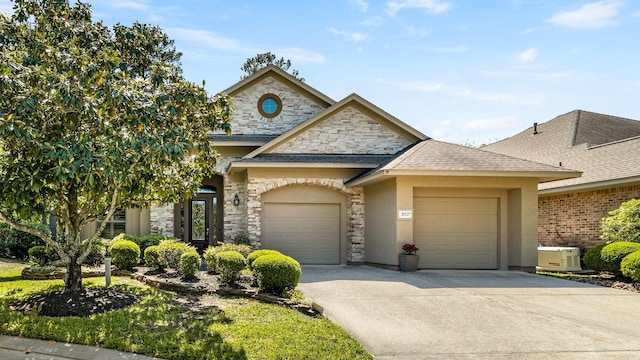 french provincial home featuring concrete driveway, an attached garage, a shingled roof, stone siding, and stucco siding