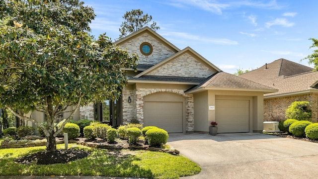 french provincial home with concrete driveway, a garage, stone siding, and a shingled roof