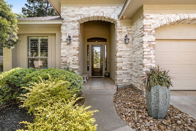 property entrance with an attached garage and stone siding