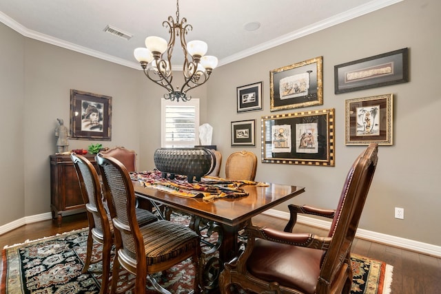 dining room with visible vents, baseboards, wood finished floors, and a chandelier