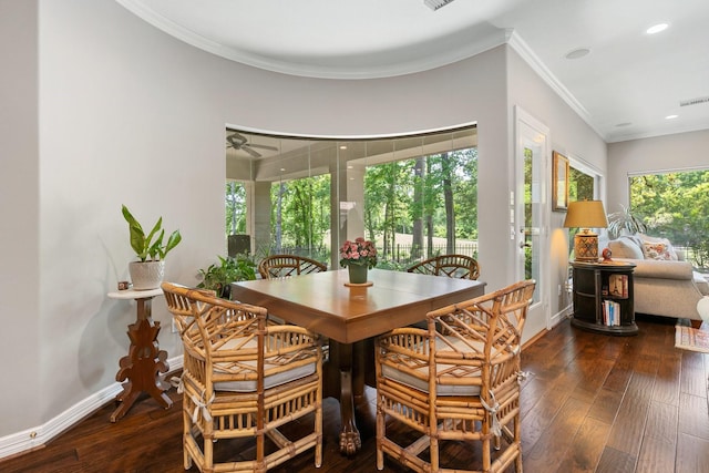 dining space featuring crown molding, baseboards, wood-type flooring, and recessed lighting