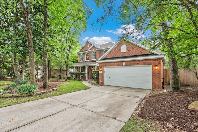 view of front of house featuring fence, an attached garage, concrete driveway, and brick siding