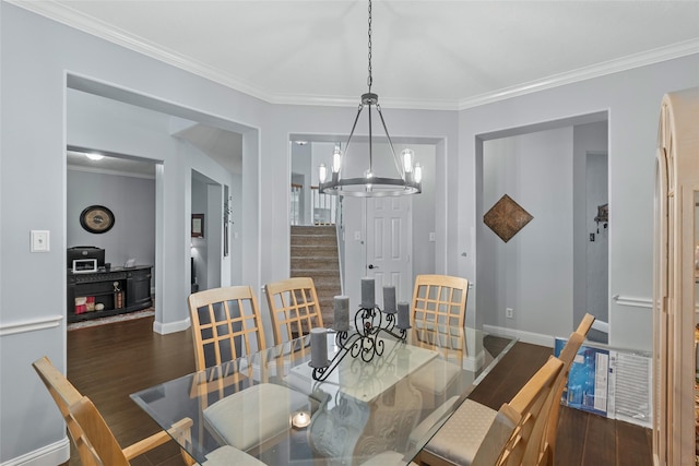 dining area featuring baseboards, stairs, wood finished floors, and a chandelier