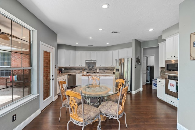dining room with baseboards, visible vents, and dark wood-type flooring