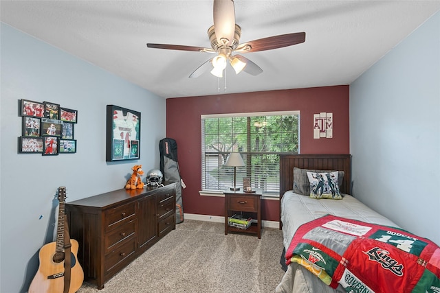 bedroom featuring ceiling fan, light carpet, and baseboards