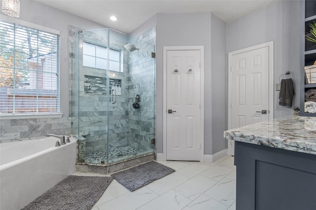 full bathroom featuring a healthy amount of sunlight, a garden tub, and a stall shower