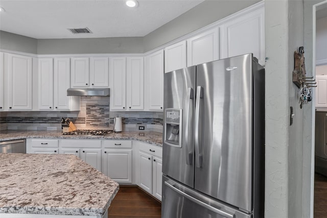 kitchen featuring white cabinets, stainless steel appliances, dark wood-style flooring, and visible vents