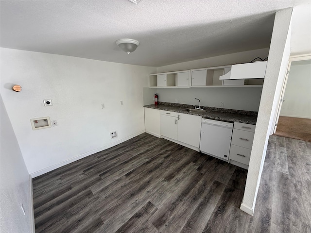 kitchen with dark countertops, open shelves, dark wood finished floors, dishwasher, and a sink