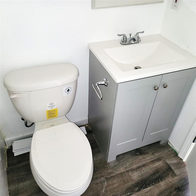 bathroom featuring toilet, wood finished floors, and vanity