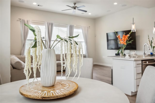 dining space with a ceiling fan, baseboards, recessed lighting, and wood finished floors