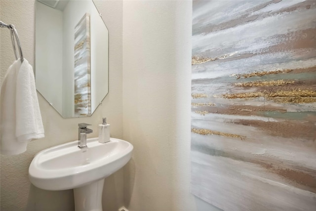 bathroom with a sink and a textured wall
