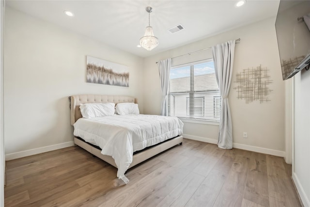 bedroom featuring recessed lighting, baseboards, light wood finished floors, and visible vents
