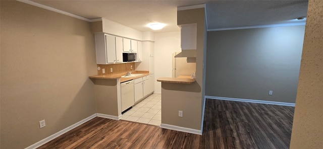 2350 Bering Dr Unit 114, Houston, TX 77057 - kitchen featuring white dishwasher, black microwave, a sink, light wood finished floors, and ornamental molding
