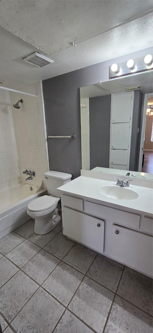 2350 Bering Dr Unit 114, Houston, TX 77057 - bathroom featuring visible vents, vanity, a textured wall, washtub / shower combination, and a textured ceiling
