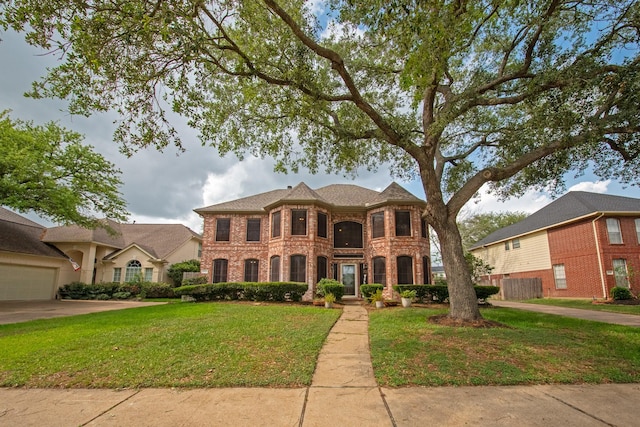 view of front of home with a front yard and brick siding