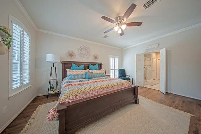 bedroom with crown molding, wood finished floors, and visible vents