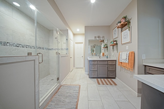 full bath with vanity, baseboards, a stall shower, and recessed lighting
