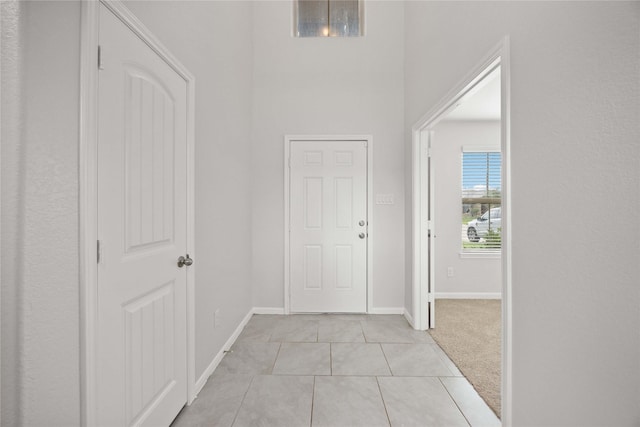 interior space featuring baseboards and light tile patterned floors