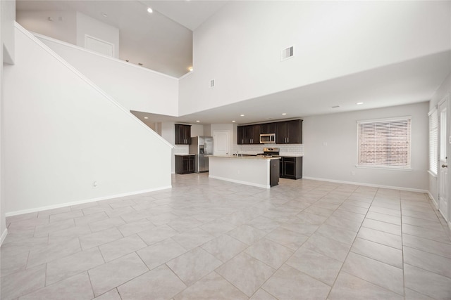 unfurnished living room featuring recessed lighting, baseboards, and visible vents