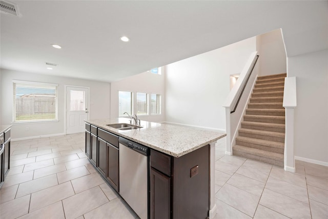 kitchen with stainless steel dishwasher, light tile patterned flooring, visible vents, and a sink