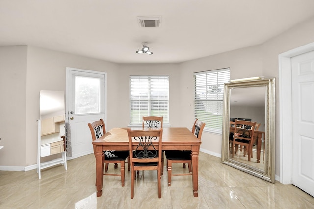dining room with baseboards, light tile patterned flooring, and visible vents